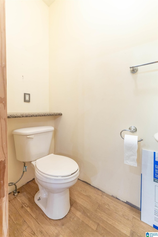 bathroom featuring toilet and wood finished floors