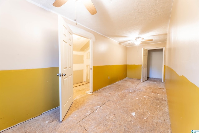 spare room with ceiling fan and a textured ceiling