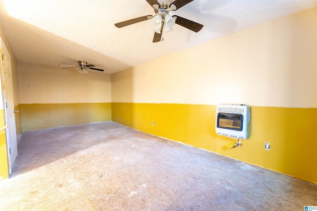 unfurnished room with heating unit, carpet flooring, and a ceiling fan