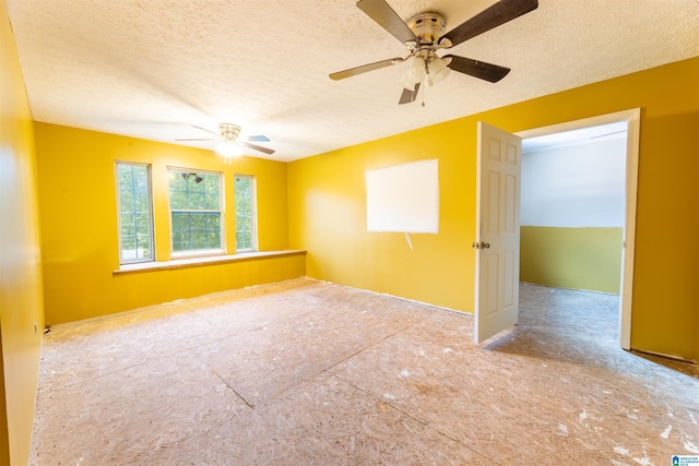 spare room featuring a textured ceiling and a ceiling fan