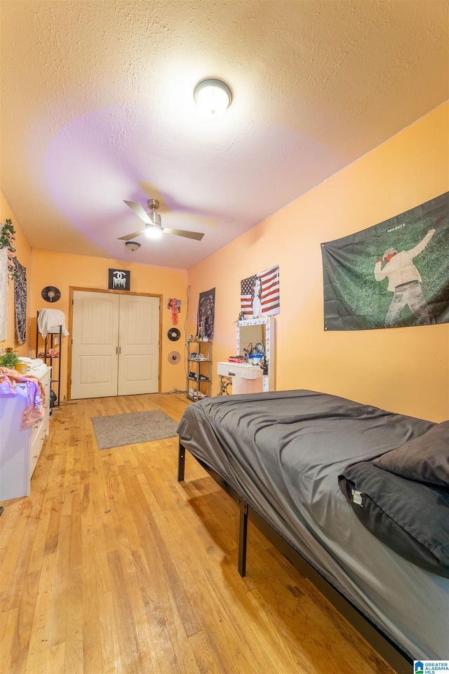 bedroom with a textured ceiling and hardwood / wood-style floors