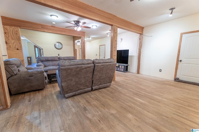 living area with hardwood / wood-style floors and a ceiling fan