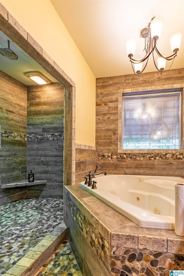 bathroom with tiled shower, a chandelier, and a whirlpool tub