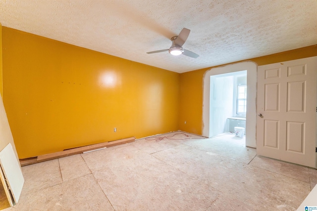 spare room with a ceiling fan and a textured ceiling