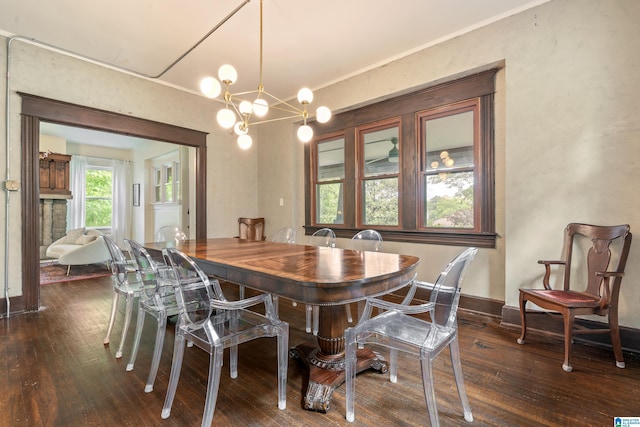dining space featuring hardwood / wood-style flooring, a chandelier, and baseboards