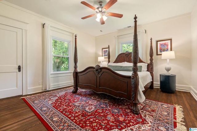 bedroom featuring wood finished floors, multiple windows, and ceiling fan