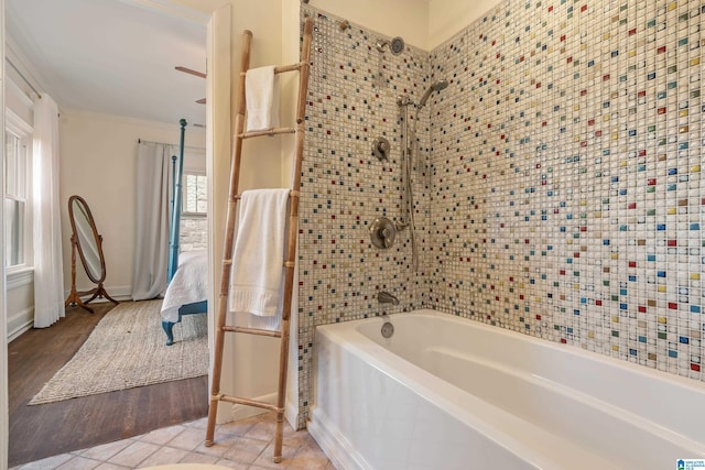 ensuite bathroom featuring shower / bathtub combination, wood finished floors, and crown molding