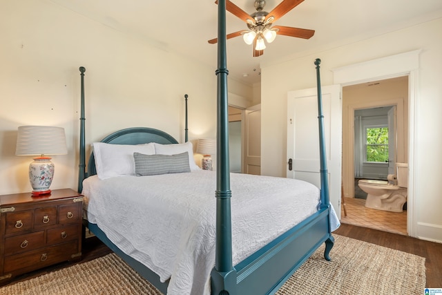 bedroom featuring wood finished floors, a ceiling fan, and ensuite bath
