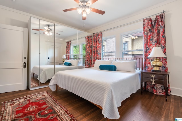 bedroom with wood finished floors, ceiling fan, and a closet