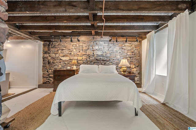bedroom featuring rail lighting