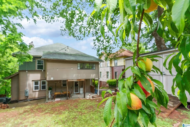 back of house with a patio and fence