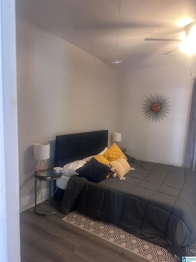 bedroom with ceiling fan and wood finished floors