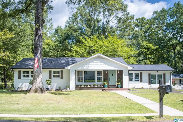 single story home featuring a porch and a front yard