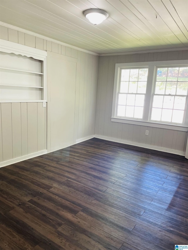unfurnished room featuring dark wood-style flooring and baseboards