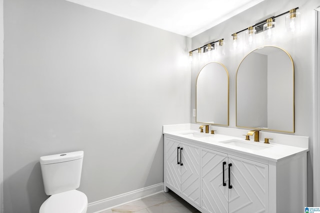 bathroom with marble look tiles, toilet, baseboards, and double vanity