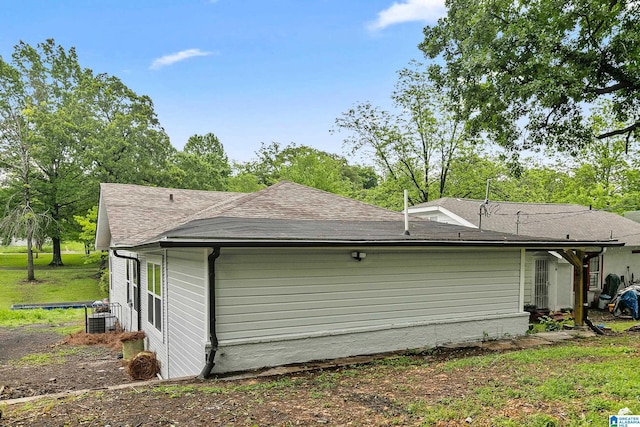 view of home's exterior with roof with shingles