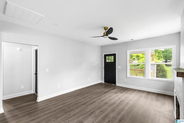 entrance foyer with dark wood-style flooring, a ceiling fan, and baseboards