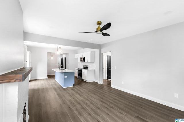 unfurnished living room with ceiling fan, baseboards, and dark wood-style flooring