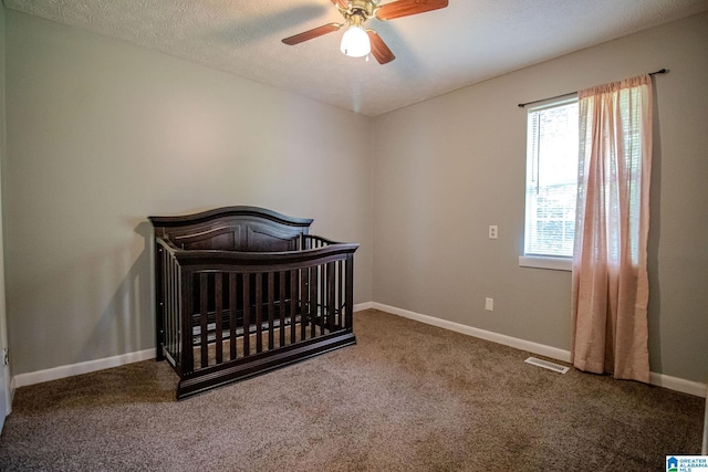 bedroom with baseboards, carpet flooring, visible vents, and a ceiling fan