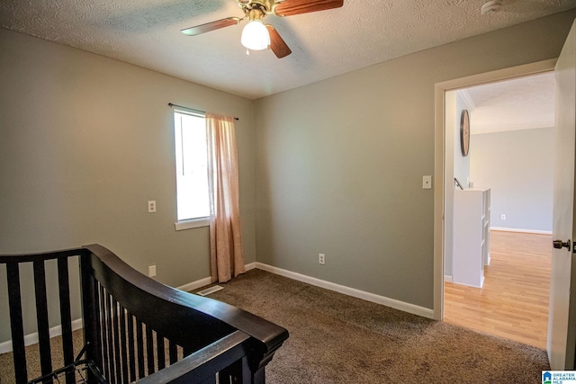 bedroom featuring a textured ceiling, baseboards, and carpet floors