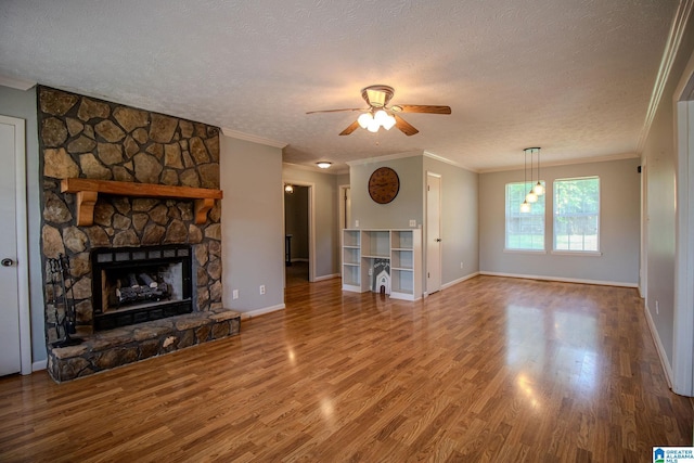 unfurnished living room with a textured ceiling, wood finished floors, baseboards, and ceiling fan