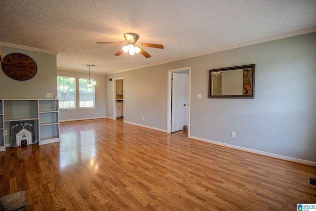 unfurnished living room with ceiling fan, a textured ceiling, ornamental molding, and wood finished floors