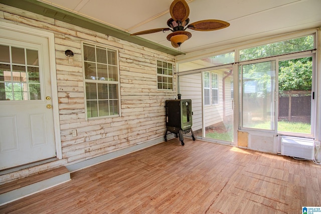 unfurnished sunroom with a ceiling fan and a healthy amount of sunlight