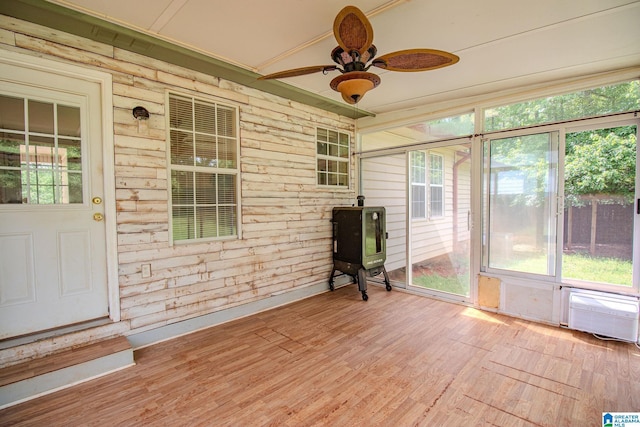 unfurnished sunroom with a ceiling fan