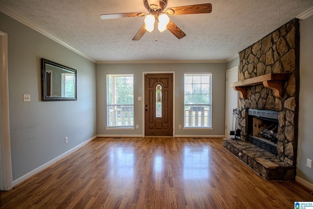 entryway featuring a textured ceiling, a wealth of natural light, and wood finished floors