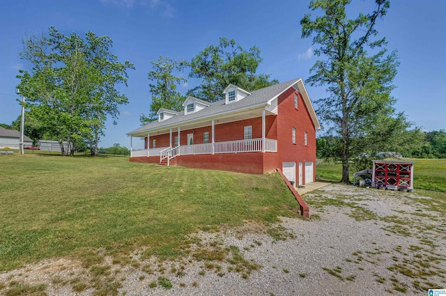 view of property exterior with a porch, an attached garage, brick siding, driveway, and a yard