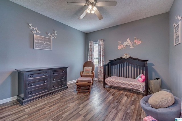 bedroom with baseboards, a ceiling fan, a textured ceiling, and wood finished floors