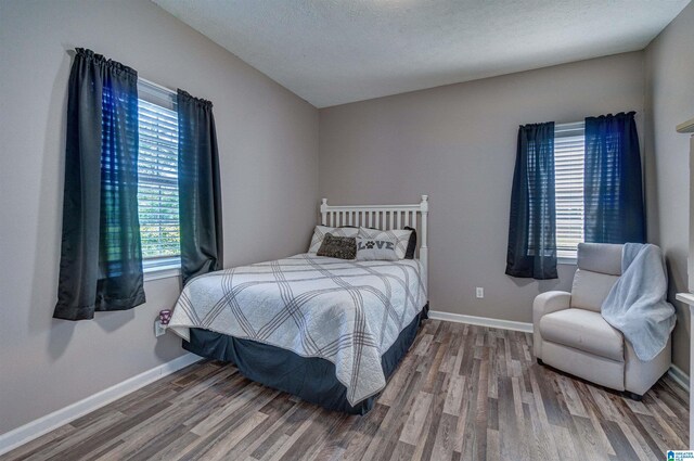bedroom featuring baseboards and wood finished floors