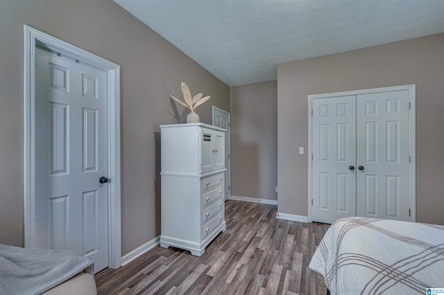 bedroom featuring baseboards, a closet, and wood finished floors