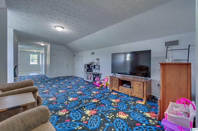 carpeted living area with lofted ceiling, baseboards, visible vents, and a textured ceiling