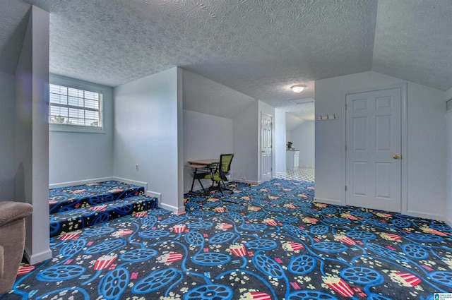carpeted bedroom with a textured ceiling, baseboards, and lofted ceiling