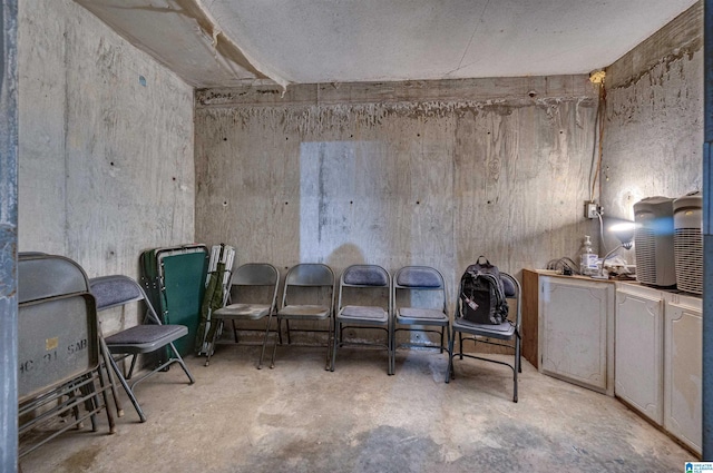 living area featuring unfinished concrete flooring