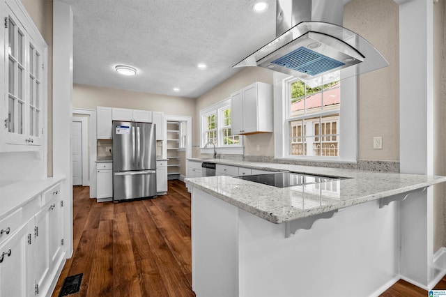 1330 Bush Blvd W, Birmingham, AL 35208 - kitchen with stainless steel appliances, island exhaust hood, a peninsula, white cabinets, and a textured ceiling