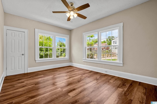 1330 Bush Blvd W, Birmingham, AL 35208 - empty room featuring wood finished floors, baseboards, a ceiling fan, and a textured ceiling
