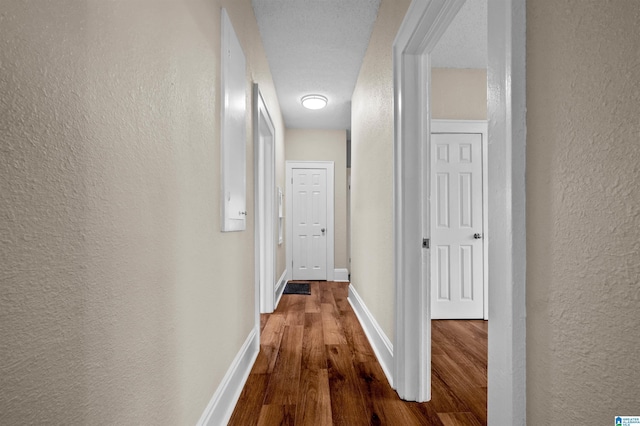 1330 Bush Blvd W, Birmingham, AL 35208 - hallway featuring a textured wall, wood finished floors, and baseboards
