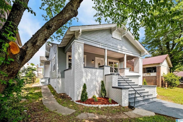1330 Bush Blvd W, Birmingham, AL 35208 - view of front of property with stairway, covered porch, and brick siding