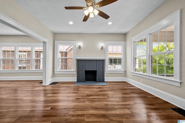 1330 Bush Blvd W, Birmingham, AL 35208 - unfurnished living room featuring baseboards, ceiling fan, wood finished floors, a brick fireplace, and recessed lighting