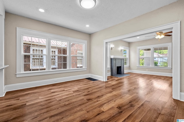 1330 Bush Blvd W, Birmingham, AL 35208 - unfurnished living room featuring wood finished floors, a fireplace, baseboards, recessed lighting, and ceiling fan