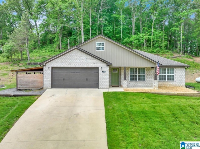 view of front of home featuring an attached garage, concrete driveway, brick siding, and a front yard