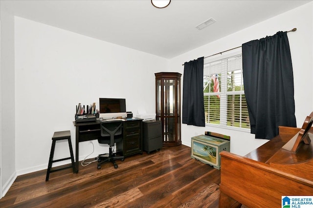 home office featuring baseboards, visible vents, and dark wood finished floors