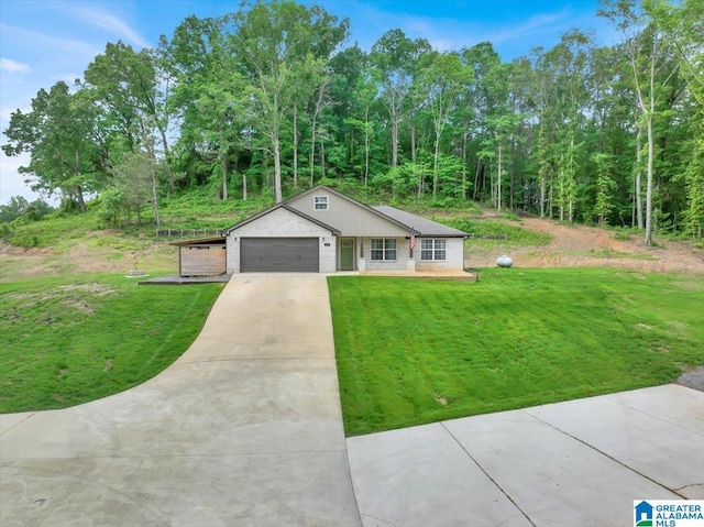 view of front of home with concrete driveway, brick siding, an attached garage, and a front lawn