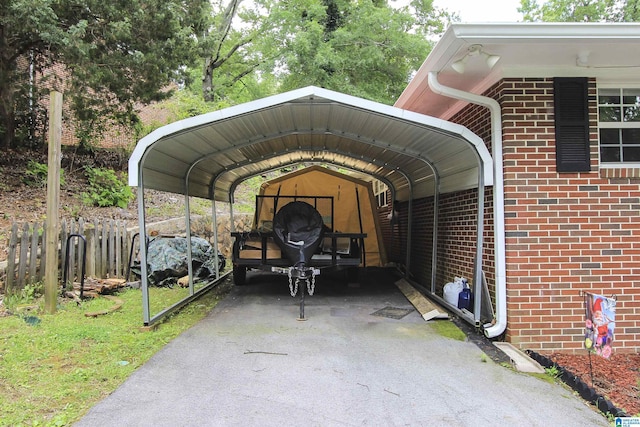 view of vehicle parking with driveway and a detached carport