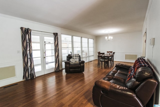 living room with a chandelier, french doors, visible vents, and dark wood finished floors