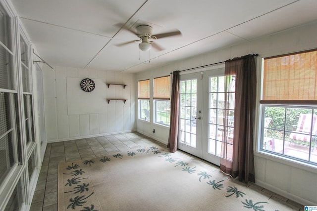 spare room featuring baseboards, french doors, and ceiling fan