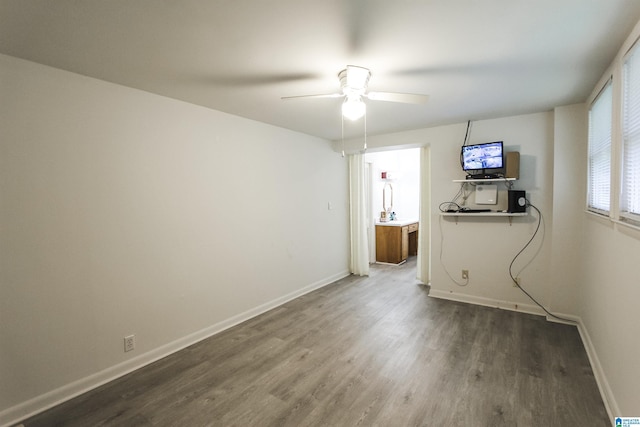 unfurnished living room featuring wood finished floors, baseboards, and ceiling fan