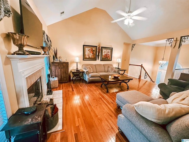 971 Old Cahaba Dr, Helena, AL 35080 - living area featuring a ceiling fan, a tile fireplace, light wood-style flooring, high vaulted ceiling, and a chandelier